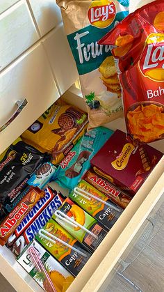 an open drawer filled with snacks and candy