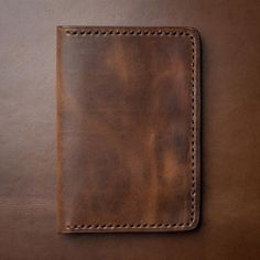 Our Brown Leather Passport Covers add a touch of professionalism to your travel kit. The rich character of Heritage Brown leather will age gracefully as it travels with you over the years. The dense yet supple feel of the leather will be a welcome warmth whenever you pull it out at the airport. Over time, this passport cover will become as indispensable as the contents inside. Our full-grain Horween leather means your passport cover will develop character and patina through your travels. We hand Classic Leather Travel Accessories With Luggage Sleeve, Classic Brown Travel Accessories With Luggage Sleeve, Classic Brown Travel Accessories For Business Trips, Classic Leather Rectangular Travel Accessories, Classic Cognac Wallets For Travel, Brown Leather-lined Wallet For Travel, Brown Leather Rectangular Travel Accessories, Leather Travel Accessories With Card Slots For Daily Use, Travel Wallets With Leather Lining In Brown