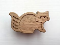 a wooden brooch with an animal design on it's back end and eyes