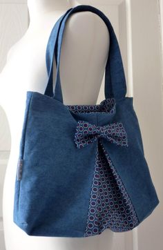 a blue bag with a bow on it