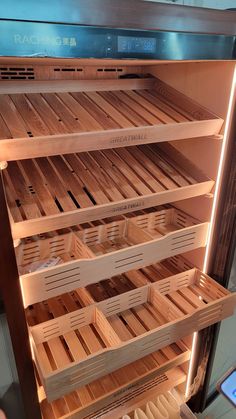 an oven with wooden shelves and lights inside