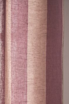 a close up view of a curtain with pink and beige stripes