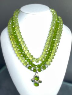 "Bold, dramatic, gorgeous green faceted stones Peridot, crystal and silver beads Crystal and silver box clasp Silver and peridot pendant (1.5\"L x 1\"W) Length - 22\"OA #356- \"SPRING GREEN\"" Elegant Green Crystal Necklaces With Polished Beads, Green Crystal Necklace With Stones, Elegant Green Crystal Necklaces, Elegant Green Crystal Necklace, Elegant Green Faceted Crystal Necklaces, Elegant Green Crystal Necklace With Faceted Beads, Green Crystal Beaded Necklaces As Gift, Green Crystal Beaded Necklace For Gift, Handmade Green Crystal Necklaces