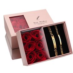 two pink boxes with red roses and gold bracelets in them, one is open