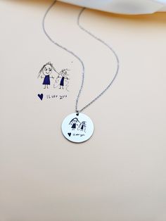 Kids Drawing Necklace, Children Handwriting Necklace for Mom, Custom Child Artwork Jewelry, Personalized Gift for Grandma, Keepsake Jewelry. Turn your children's drawing or writing into a necklace. This necklace is not just an accessory, it's a precious keepsake that celebrates the boundless creativity of your little one. Your child's cherished drawing forever preserved in a stainless steel charm. Each line, every curve, and all the details are meticulously engraved with laser precision, ensuring that the essence of your child's artwork is beautifully preserved. HOW TO ORDER Scan or take a picture of the design, use the ASK A QUESTION OR CONTACT SHOP OWNER button to send us your design. Material: Stainless Steel, Gold or Rose Gold Plated Stainless Steel. Finish: Stainless Steel, Gold, Rose Handmade Charm Necklace For Birthday And Mother's Day, Artistic Personalized Necklace, Artistic Personalized Round Necklace, Artistic Personalized Round Pendant Necklace, Adjustable Stamped Necklace For Gifts, Artistic White Necklace For Gift, Adjustable Stamped Necklace As Gift, Handmade Round Charm Necklace For Birthday, Mother's Day Hand Stamped Necklace Gift