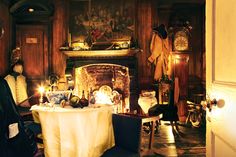 a dining room with a table and chairs next to a fire place in the fireplace