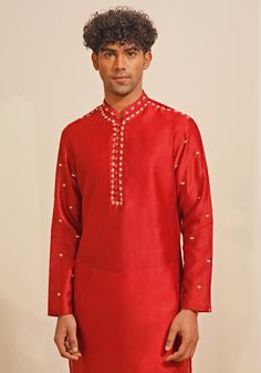 Presenting a regal Red Silk Kurta Set, featuring a Chinese collar and looped fabric buttons for a classic look. The hand-embroidered details on the neckline, shoulder, and sleeves add a touch of elegance. Paired with white pants, this ensemble is perfect for Mehendi or Sangeet events, offering a blend of traditional charm and sophisticated style. Composition : Chanderi Silk Care: Dry Clean Only and Vacuum Storage This product can be customized for sleeves, length and colour Delivery : 4-6 weeks as the product is hand crafted. Check Size Guide or choose MySize for free customisation (All Sizes above XL can be made at 15% additional cost) For more information and sizes please contact fabiliciousfashion@gmail.com or visit our Copenhagen studio. About the Designer : Shreyansh, a distinguished Traditional Sets With Embroidered Neckline For Festivities, Traditional Festive Sets With Embroidered Neckline, Fitted Straight Kurta Set With Embroidered Neckline, Traditional Sets With Embroidered Neckline For Diwali, Traditional Set With Embroidered Neckline For Diwali, Traditional Kurta With Embroidered Neckline For Diwali, Festive Designer Traditional Wear With Embroidered Neckline, Traditional Wedding Sets With Embroidered Neckline, Eid Festival Fitted Set With Embroidered Neckline