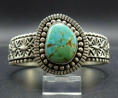 "VINTAGE NAVAJO BRACELET DESCRIPTION: Heavy gauge hand-stamped sterling silver band adorned with a gorgeous specimen of Royston turquoise, this impressive bracelet will be a cherished addition to your collection of fine vintage Native American jewelry. MEASUREMENTS: Interior of the cuff measures 5 1/8\" with an additional 7/8\" non-adjustable gap. Total circumference: 6\" Measures 2 1/8\" straight across the widest part (from wrist bone to wrist bone) Band measures 1/2\" wide Cabochon measures 1 Antique Stamped Turquoise Jewelry, Vintage Turquoise Stamped Bracelets, Vintage Turquoise Cuff Bracelet Stamped 925, Turquoise Stamped Cuff Bracelet Collectible, Southwestern Turquoise Cuff Bracelet, Vintage Turquoise Stamped Cuff Bracelet, Vintage Turquoise Cuff Bracelet, Vintage Turquoise Sterling Silver Cuff Bracelet, Luxury Southwestern Kingman Turquoise Cuff Bracelet