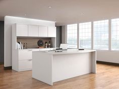 an empty kitchen with white cabinets and wood floors in front of large windowed windows