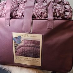 there is a purple bag with pink flowers on it