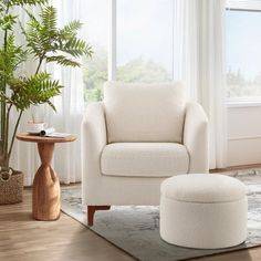 a living room with a white chair and footstool in front of a window