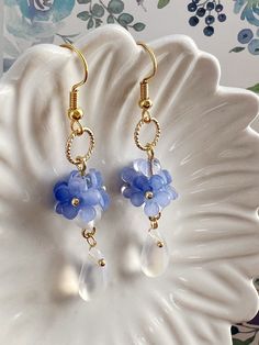 Embrace the timeless beauty of these handmade earrings adorned with delicate little blue "Forget Me Not" flowers, symbolizing love and fidelity.  Suspended from each blossom, glistening crystal drops add a touch of sparkle and allure. With their understated charm and handmade craftsmanship, they make a captivating addition to any ensemble, infusing it with grace and romance. A perfect gift for her, these earrings exude elegance, making them an exquisite choice for bridal wear or as a captivating Delicate Blue Flower Earrings With Ear Wire, Dainty Blue Earrings For Gifts, Dainty Blue Drop Earrings, Blue Flower Earrings For Jewelry Making, Blue Drop Flower Earrings With Ear Wire, Blue Round Flower Earrings Hypoallergenic, Blue Drop Flower Earrings, Blue Round Hypoallergenic Flower Earrings, Delicate Blue Flower Earrings