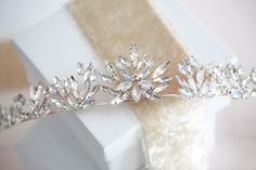 Steal the spotlight with our white opal crown. Elegantly crafted with white opal and clear crystals. It will make you feel like a princess on your wedding day. Surprisingly lightweight! - Created with premium European white opal and clear crystals - Available in rose gold, light gold, and silver. - Tiara measures 14 inches x 1.4 inches - Nickel free and hypoallergenic Browse My Entire Shop For More Jewelry & Accessories: https://www.etsy.com/shop/TheExquisiteBride Browse My Shop For Earrings: ht White Tiara, Rose Gold Crown, Rose Gold Tiara, Silver Tiara, Wedding Hair Wreath, Gold Tiara, Gold Wedding Decorations, Gold Crown, Wedding Tiara