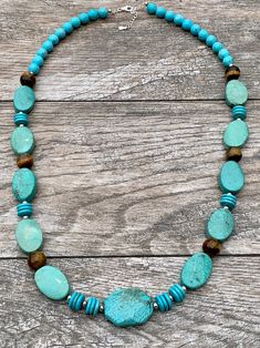 Turquoise Magnesite, Agate & Sterling Silver Statement Necklace Genuine Turquoise Magnesite Genuine Agate Sterling Silver Lobster Claw Clasp Crafted and Finished by Hand Approximate Measurements: Length 30" Adjustable with 2" Extender Live your best life when you are wearing this powerful gemstone statement necklace. This necklace will pair perfectly layered over a turtleneck or tunic or pair with a V-neck t-shirt and a pair of jeans. Turquoise Gemstone Necklaces With Round Beads, Artisan Turquoise Amazonite Jewelry, Turquoise Agate Gemstone Beaded Necklaces, Turquoise Agate Beaded Necklace With Gemstones, Turquoise Agate Beaded Necklace, Turquoise Agate Gemstone Beaded Necklace, Turquoise Blue Necklace With Natural Amazonite Stones, Turquoise Amazonite Polished Beads Necklace, Turquoise Amazonite Necklace With Polished Beads