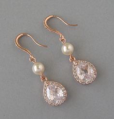 Cubic Zirconia and Swarovski pearl earrings are available with rose gold plated, rhodium plated and yellow gold plated finish. Also the earrings are available with white and cream pearls. Please select the finish and pearl color for earrings before checkout. Earrings are about 1 5/8 inch (4.1cm) long. Materials and sizes: Swarovski pearls are made in Austria. Pearls size: 6mm Pearl color: white or cream Teardrops are 16mm high and 11mm wide. Zircon color: clear 1) Rose gold plated over brass dro Bridal Jewels, Pearls Earrings, Bridesmaid Gifts Jewelry, Earrings Rose Gold, 1 Rose, Earrings Bridesmaid, Pearl Cream, Set Necklace, Pearl Set