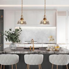 an elegant kitchen with marble counter tops and gold pendant lights hanging over the bar area