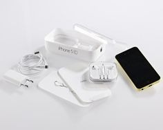 an apple iphone 5g and its accessories laid out