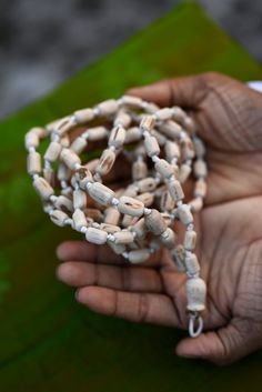 "Introducing our exquisite Tulsi Japa Mala, a sacred accessory designed for meditation and prayer, crafted with utmost care and devotion. This spiritual tool is handcrafted with precision, featuring 108 cylindrical beads made from the sacred Tulsi wood. Each bead is a testament to the rich tradition and cultural significance that Tulsi holds in spiritual practices. Mala Length 40 inches. The Tulsi Japa Mala boasts a unique design, with its cylindrical beads gradually decreasing in size from a substantial bead size of 2 cm to a smaller, delicate size of 1.5 cm. This meticulously crafted arrangement not only enhances the aesthetic appeal of the Mala but also ensures a comfortable grip and smooth touch, allowing your fingers to glide over the beads effortlessly during your meditation and pray Hand Wrapped Mala For Meditation, Hand Wrapped Mala With Round Beads For Meditation, Hand Wrapped Round Beads Mala For Meditation, Traditional Natural Necklace For Meditation, Handmade Spiritual Mala For Puja, Holistic Healing Mala With Wooden Beads, Traditional Natural Beads As A Gift, Traditional Natural Beads For Gifts, Spiritual Rosary With Large Beads