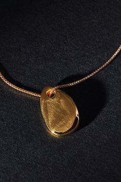 Gold: 14k gold-plated brass Silver: Sterling silver Clasp styling Imported | Small Pebble Pendant Necklace by Maslo in Gold, Women's, Gold/Plated Brass/Sterling Silver at Anthropologie Modern Gold Plated Oval Pendant Necklace, Gold Tarnish Resistant Oval Pendant Necklace, Yellow Gold Plated Teardrop Jewelry, Gold Brass Necklace Fine Jewelry, Everyday Gold Teardrop Jewelry, Modern Gold-plated Teardrop Jewelry, Fine Jewelry Gold Brass Necklace, Gold Tarnish-resistant Oval Pendant Necklace, Teardrop Yellow Gold Plated Jewelry