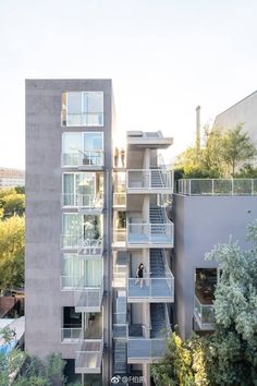 an apartment building with stairs leading up to the second floor and two stories above it