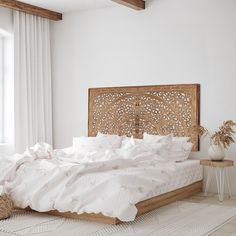 a bed with white sheets and pillows in a room next to a window that has wooden beams