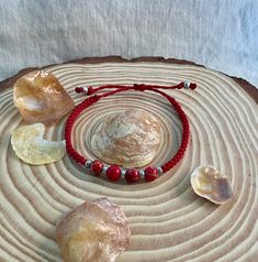 Embrace your boho-chic side with this stunning Red Beaded Macrame Bracelet. Crafted with a blend of polyester waxed thread and 4 beads, this adjustable bracelet is the perfect accessory to add a pop of color and effortless style to any outfit. The intricate macrame design and natural stone details give this bracelet a one-of-a-kind, handmade feel, while the adjustable thread allows for a customized fit. Whether you're strolling through the farmer's market or enjoying a sunset picnic, this red st Bohemian Red Hand-strung Braided Bracelets, Bohemian Red Beaded Bracelets For Beach, Red Hand Wrapped Beaded Bracelets For Beach, Red Hand-wrapped Beaded Bracelet For The Beach, Red Hand Wrapped Beaded Bracelet For Beach, Red Bohemian Macrame Jewelry, Red Bohemian Jewelry For The Beach, Red Bohemian Jewelry For Beach, Bohemian Red Jewelry For Beach