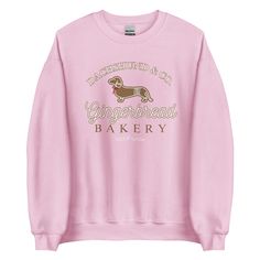 A pink sweatshirt with a gingerbread dachshund design for Christmas Pink Christmas Sweatshirt, Gingerbread Bakery, Bandana Blanket, Christmas Fits, Bow Tie Collar, Dachshund Lovers, Weiner Dog, Wiener Dog, Dog Hoodie