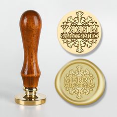 a rubber stamp with the words merry christmas on it next to a gold wax seal