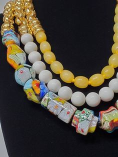 "Beautiful vintage Murano glass beads and dyed jade beads create a one of a kind necklace. Gold rings add shine to the top half of each strand. The necklace has a toggle clasp. ●Dimensions: L:22\" ●Linda's Designers Group features a collection of unique fine china, luxury estate sale handbags, vintage statement jewelry and handmade 'one of a kind' jewelry. We will gladly provide additional images or information, contact us through this site or our Facebook page. Follow us on Facebook and Instagr White Glass Necklace With Colorful Beads, Colorful Glass Beaded Jewelry, Oval Glass Gemstone Beads Jewelry, Glass Multi-strand Jewelry With Large Beads, White Glass Beaded Necklace With Large Beads, Multi-strand Glass Beaded Jewelry, Multi-strand Glass Bead Jewelry, Bohemian Yellow Glass Necklace, Costume Jewelry Necklaces With Czech Glass Polished Beads