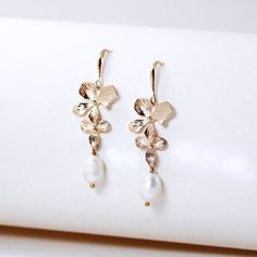 orchid flower pearl bridal earrings Gold Plated Flower Charm Earrings For Wedding, Floral Pearl Charm Earrings For Wedding, Dainty Baroque Pearl Earrings For Wedding, Gold Flower Earrings With Pearl Charm, Dainty Baroque Pearl Wedding Earrings, Gold Pearl Earrings With Flower Charm For Wedding, Delicate Pearl Drop Earrings With Flower Shape, Delicate Pearl Drop Earrings In Flower Shape, Delicate Flower-shaped Earrings With Pearl Charm