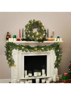 a christmas mantle with candles and wreath on top