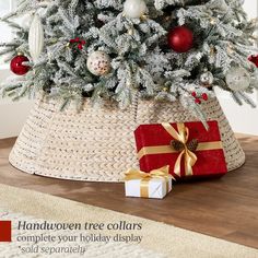 a christmas tree in a basket with presents under it and the words handwritten tree collars complete your holiday display