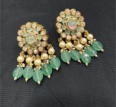 These stunning Sabyasachi inspired earrings are the perfect addition to any jewellery collection. Featuring a beautiful moissanite stone set in a polki kundan design, these earrings are sure to catch the eye and make a statement. The dangle/drop style is perfect for both casual and formal occasions, and the earrings are crafted with the highest quality materials to ensure they last for years to come. Whether you're looking for a gift for a loved one or simply want to treat yourself, these earrings are a must-have. They are ideal for those who appreciate designer jewellery and want to add a touch of elegance to their outfit. So why wait? Add these gorgeous earrings to your collection today and make a statement wherever you go! Elegant Chandbalis With Cutdana For Designer Wear, Designer Kundan Earrings For Diwali, Bollywood Style Designer Earrings With Cutdana, Bollywood Cutdana Earrings For Designer Wear, Bollywood Designer Cutdana Earrings, Designer Chandbali Jhumkas With Stone Work, Designer Chandbali Earrings With Latkans, Designer Chandbali Earrings For Festive Occasions, Bollywood Style Earrings With Latkans For Designer Wear