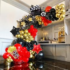 a bunch of balloons that are on top of a table in front of a counter