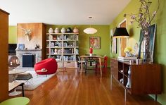 a living room filled with furniture and a fire place next to a bookshelf