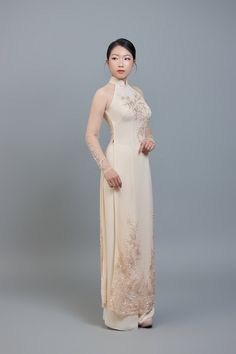 Custom made ao dai (Vietnamese traditional dress) champagne color chiffon (price includes pants worn underneath ao dai dress). After ordering we will send you a quick and simple form to guide you through taking the measurements we require for an amazing fit. Shipping details: Please allow 3-4 weeks for custom making and shipping, once measurements are received. Colors: Please note; we make every effort to ensure our photos accurately represent the true colors of each garment, but due to the natu Champagne Ao Dai, Traditional Beige Lace Dress, Intricate Embroidery Ao Dai For Wedding, Ceremonial Fitted Ao Dai With Intricate Embroidery, Fitted Ao Dai With Intricate Embroidery For Ceremony, Ceremony Ao Dai With Intricate Embroidery, Elegant Ao Dai With Lace Sleeves For Wedding, Elegant Wedding Ao Dai With Lace Sleeves, Fitted Dress With Sheer Sleeves For Ceremonies