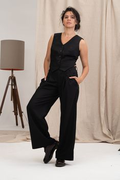 Inspire them all in the classic wool womens waistcoat. This linen clothing features a traditional construction with a front button closure. The black wool vest women also has two front pockets. This extravagant womens waistcoat is versatile for any occasion! The black wool waistcoat women is designed to be comfortable and not troublesome to wear. After wearing this stylish clothing, you will love it even more. Pair this wool waistcoat women with a shirt and pants for an effortless bohemian look. Genderless Formal Wear, Elegant Sleeveless Wool Vest, Elegant Wool Vest For Workwear, Fall Workwear Sweater Vest With Buttons, Elegant Black Wool Vest, Wool Vest With Pockets For Work, Vintage Sweater Vest For Fall Workwear, Elegant Sleeveless Wool Sweater Vest, Tailored Black Wool Vest