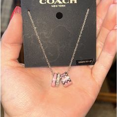 Brand New Coach Necklace. Never Opened Or Worn, Silver Chain, Pink Hoops And One With Design. One Silver Hoop Has Diamonds. Coach Rose Gold Jewelry For Gifts, Coach Sterling Silver Jewelry As A Gift, Coach Sterling Silver Jewelry, Silver Coach Jewelry For Gift, Coach Silver Jewelry For Gift, Coach Silver Jewelry, Elegant Coach Sterling Silver Jewelry, Coach Elegant Sterling Silver Jewelry, Coach Necklace With Adjustable Chain For Gift