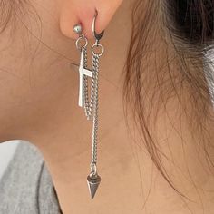 a close up of a person wearing some kind of earring with chains attached to it