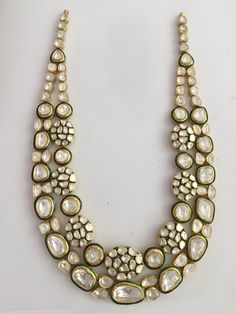 an elaborate necklace with pearls and stones