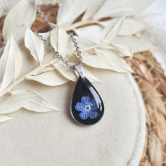 Teardrop black necklace for woman, unique resin jewelry, pendant with forget me not, botanical charm gift This is beautiful and elegant handmade jewelry, perfect gift for birthday or your beloved girlfriend for date.  Unique jewelry handmade with resin epoxy an dried flowers. This lightweight and cute necklace is for everything occassion. The jewellery I create is handmade with the utmost care.For my jewellery, I use dried flowers , most of which I collect and dry myself. The Colie brand  was bo Black Flower Charm Pendant Jewelry, Black Jewelry With Flower Charm Pendant, Black Flower Jewelry For Gift, Black Flower Necklace For Gift, Black Flower Pendant Jewelry Gift, Black Flower Pendant Necklace With Charm, Black Flower Pendant Necklace For Gift, Black Jewelry With Flower Charm As Gift, Black Pressed Flowers Jewelry Gift