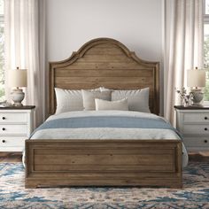 a large bed sitting in a bedroom next to two nightstands