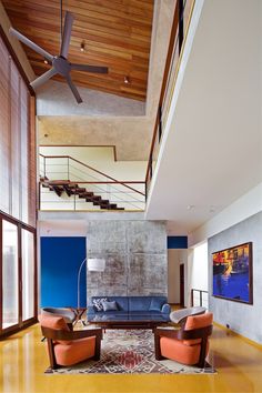 a living room filled with furniture and a ceiling fan