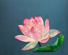 a pink flower with green leaves on a blue background is made out of colored crepe paper