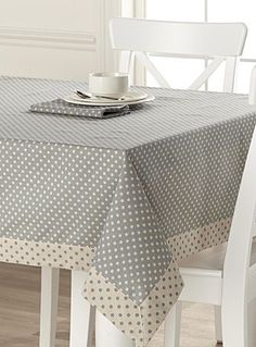 a table with a polka dot design on it and a white chair next to it