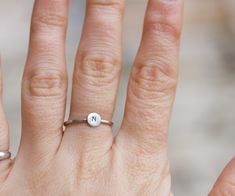 This refined initial ring is made of sterling silver and bears your's dearest initial. The outside surface may be raw and matte or shiny and polished - just state it in the message to the seller during the check-out. This ring ideally passes any style and outfit. The ring is 1 mm thick and is very sturdy although it looks very dainty on the finger. You may order just one ring or few of them - they are stackable and look pretty good together. Each letter on the ring is hand stamped and gives a fe Adjustable Initials Stackable Rings For Everyday, Everyday Adjustable Stackable Rings With Initials, Simple Stackable Initial Ring, Minimalist Sterling Silver Stackable Rings With Initials, Minimalist Hand Stamped Initial Ring As Gift, Adjustable Silver Initial Ring Hand Stamped, Sterling Silver Initial Ring For Everyday, Simple Sterling Silver Stackable Initial Ring, Adjustable Silver Hand Stamped Initial Ring