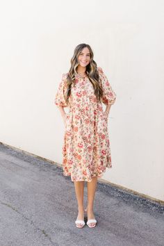 Introducing the Lindley Midi, a luxurious cream shirt dress adorned with delicate pink florals. This midi dress features a button-up design, 3/4 sleeves, and convenient pockets. Make a statement in this elegant and exclusive piece. Fits true to size. Model is wearing a small and is 5'5". Plus model is wearing a 1X and is 5'7". Size Chart Length Bust Waist S 41" 35" 35" M 42" 38" 38" L 42" 40" 40" XL 43.5" 42" 42" 1x 44" 46" 46" 2x 44" 48" 48" 3x 44" 52" 52" *Measurements are approximate and are Feminine Floral Print Midi Dress For Day Out, Cream Midi Dress For Spring, Spring Midi Dress With Ditsy Floral Print For Daywear, Spring Ditsy Floral Print Midi Dress For Daywear, Cream Midi Dress For Spring Garden Party, Spring Daywear Midi Dress With Ditsy Floral Print, Feminine Cream Midi Dress For Garden Party, Modest Floral Dress For Spring, Cream Midi Dress For Spring Daywear