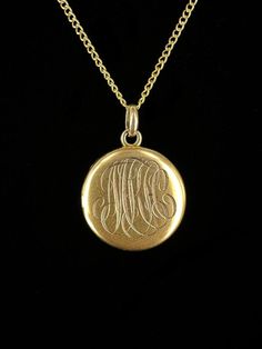 Antique Victorian 10k Gold Initial Engraved Picture Locket Necklace 18"  Item here is an antique Victorian 10k gold initial engraved picture locket necklace. This pendant is unmarked but tests for 10k gold and hangs on a 12k gold filled chain that closes with a spring ring. The initials appear to say "MKH", but are hard to make out due to the font. Locket includes two pictures of a couple from the early 1900's. Very cool and well made gold locket.  Condition: Good; item is pre-owned and may have some signs of light use and age related wear. Please look closely at the pictures provided as they are an extension of our written description. Measurements: Chain Length: 18 in Chain Width: 1.2 mm Locket: ¾ in, 1.5 dwt Weight: 3.5g 9010F Luxury Ornate Oval Pendant Necklace, Vintage 14k Gold Locket Necklace Stamped 14k, Vintage 14k Gold Locket Necklace, Ceremonial 14k Gold Medallion Jewelry, Victorian Etched Locket Necklace As Gift, Victorian Etched Locket Necklace Gift, Victorian Etched Locket Necklace For Gift, Antique Gold Vintage Charm Jewelry, Antique Gold Victorian Jewelry Gift