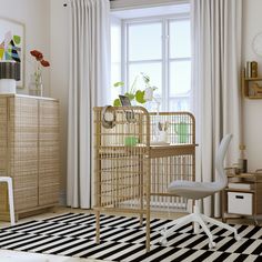 a baby crib in the corner of a room with a black and white rug