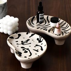 two white and black ceramic dishes on a wooden table